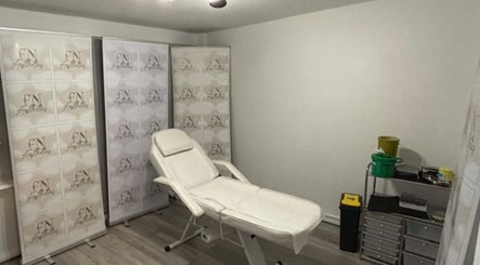 Relaxing treatment room at FN Aesthetics in Denham, England, GB showcasing a reclined spa chair.