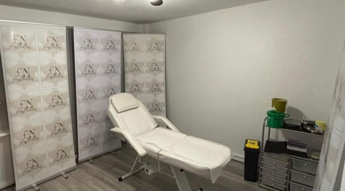 Relaxing treatment room at FN Aesthetics in Denham, England, GB showcasing a reclined spa chair.