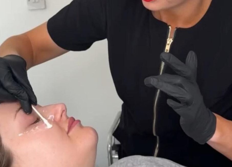 Professional eye treatment at FN Aesthetics in Denham, England, GB, focusing on precise skin application.
