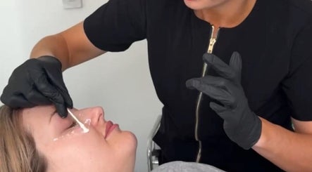 Professional eye treatment at FN Aesthetics in Denham, England, GB, focusing on precise skin application.