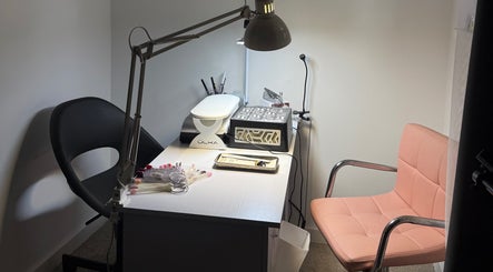 Nail studio setup at Rita’s Nails in Portsmouth, England, GB featuring a workspace with tools and pink chair.