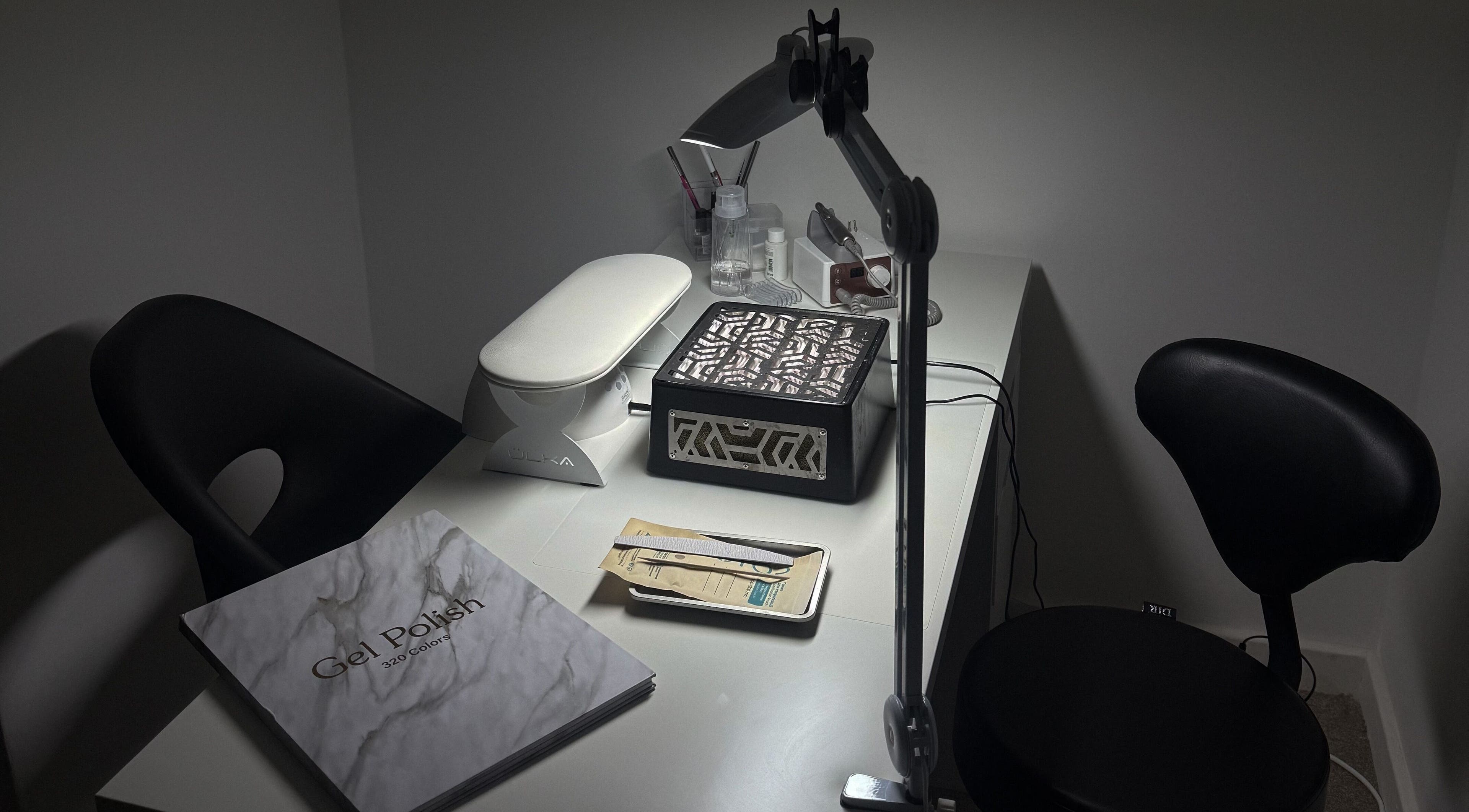 Manicure station at Rita’s Nails, Portsmouth, England, GB, featuring tools and gel polish selection.