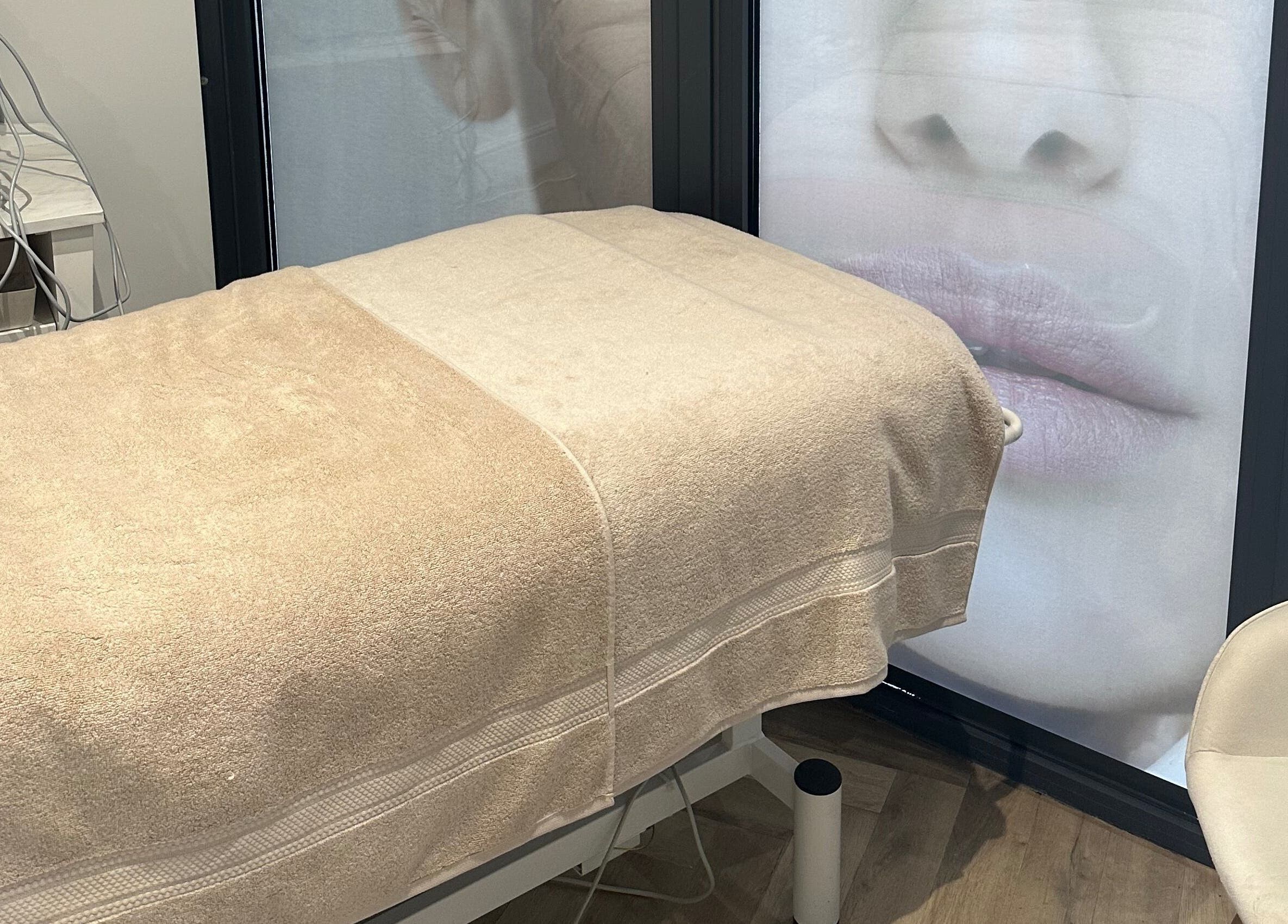 Relaxing treatment room at Timeless Aesthetics & Beauty, Lincoln, England, GB with beige bed and serene decor.
