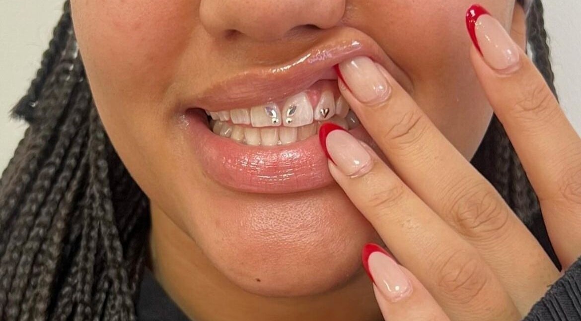 Teeth adorned with gems and manicured nails at Laterals and Lashes, Coventry, England, GB.