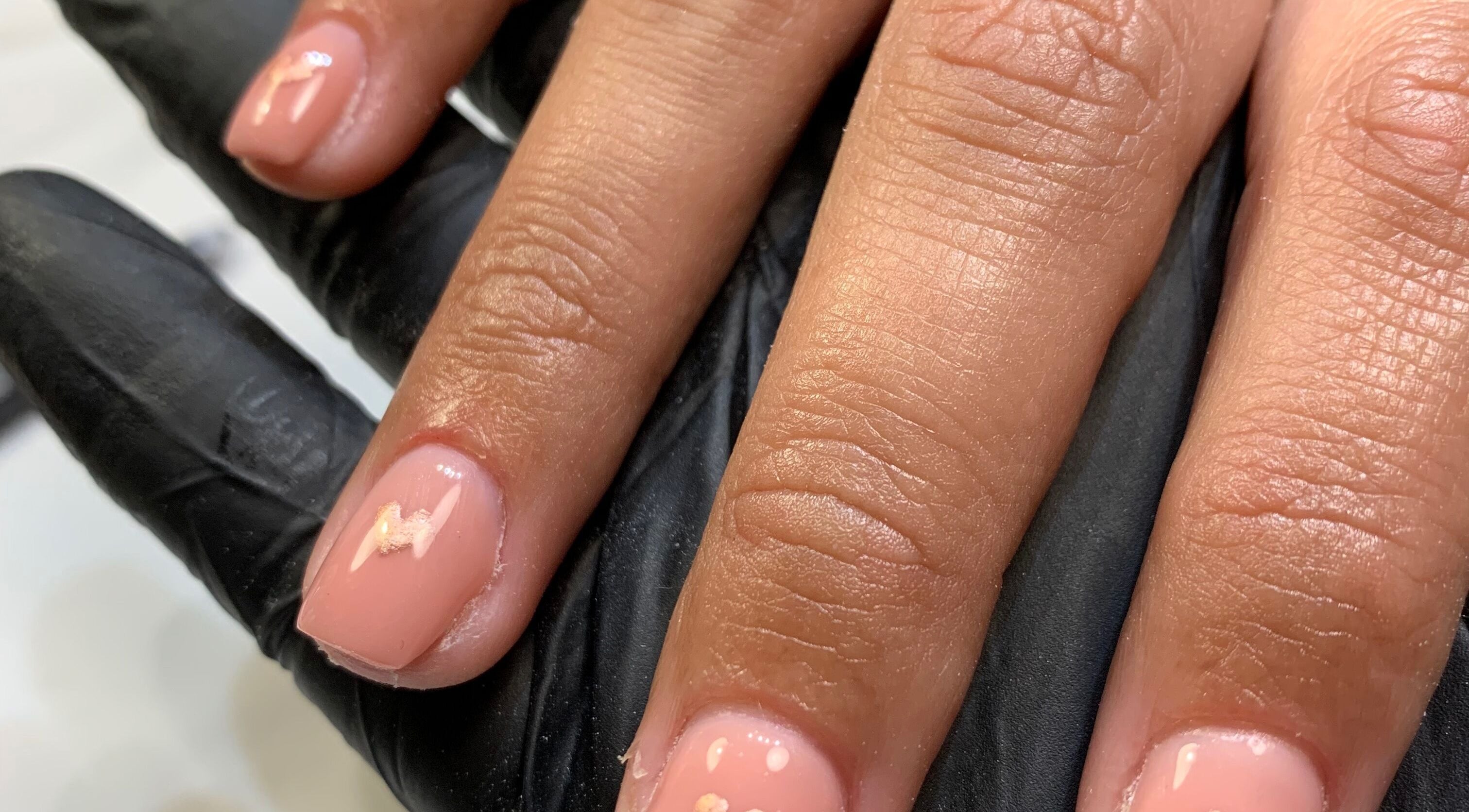 Close-up of manicured nails at Nail Tech Bec, None, England, GB, showcasing detailed pink nail art.