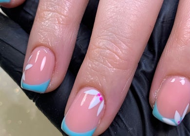 Elegant floral nail design at Nail Tech Bec, None, England, GB. Featuring blue tips and white accents.