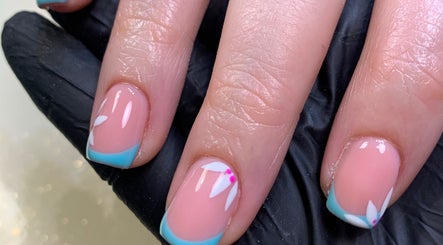 Elegant floral nail design at Nail Tech Bec, None, England, GB. Featuring blue tips and white accents.