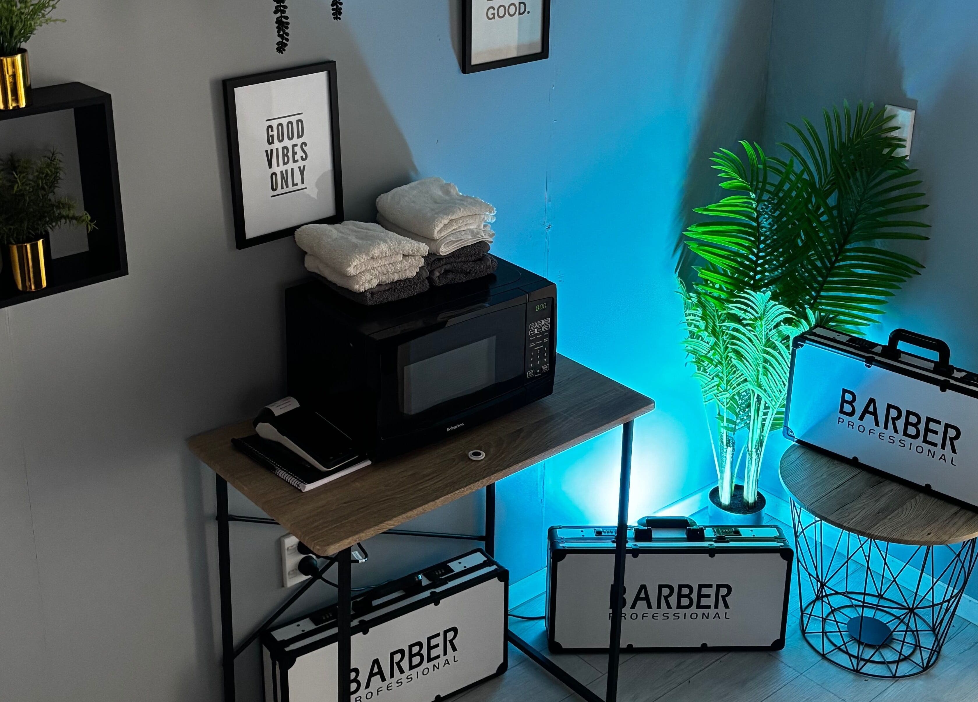 Serene corner at LH Barbershop, Paraparaumu, Wellington, NZ with plants, towels, and barber cases.