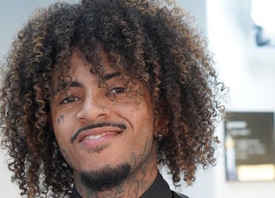 Smiling client with curly hair at LH Barbershop in Paraparaumu, Wellington, NZ.