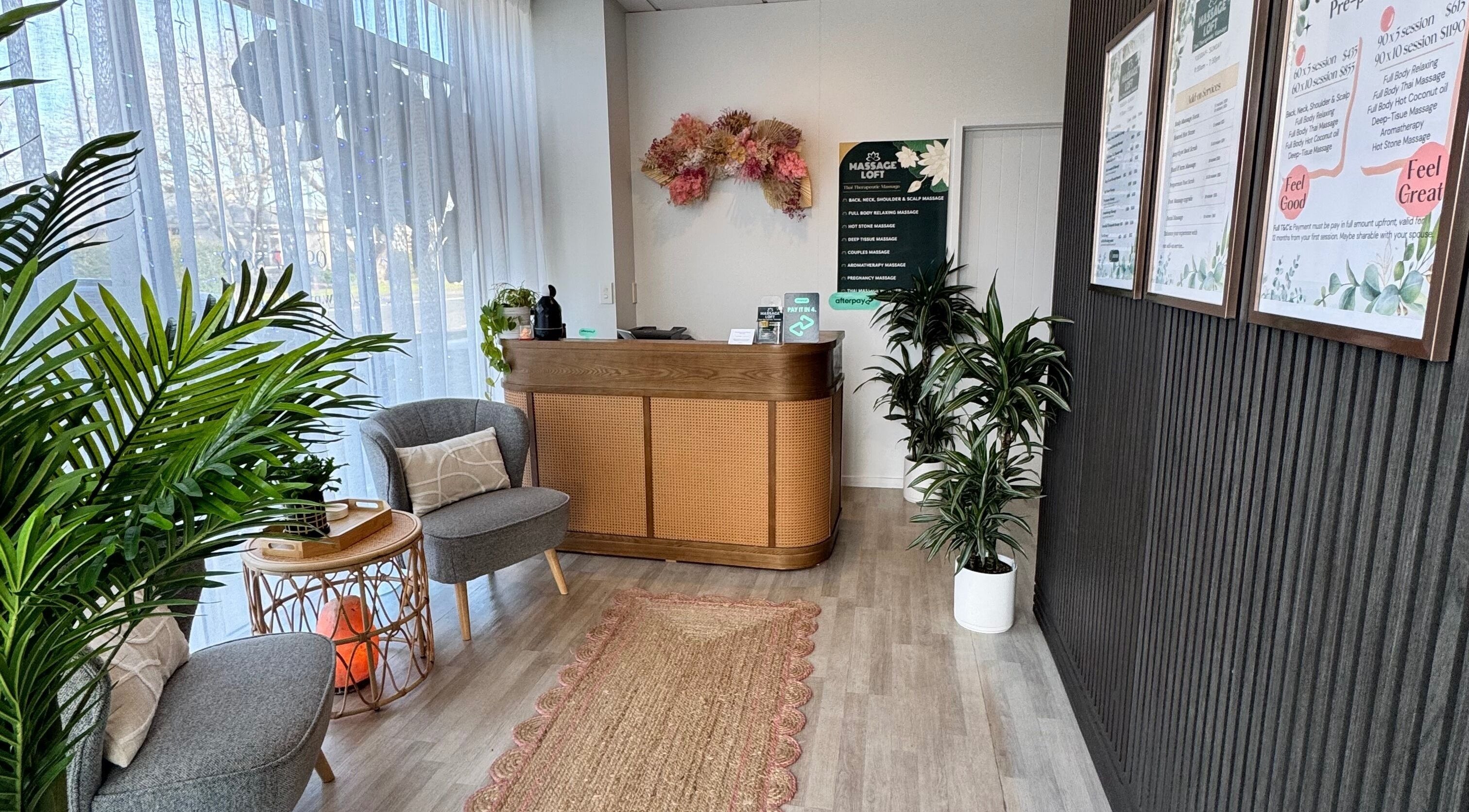 Welcoming reception area at Massage Loft (Pukekohe), Pukekohe, Auckland, NZ with cozy seating and greenery.