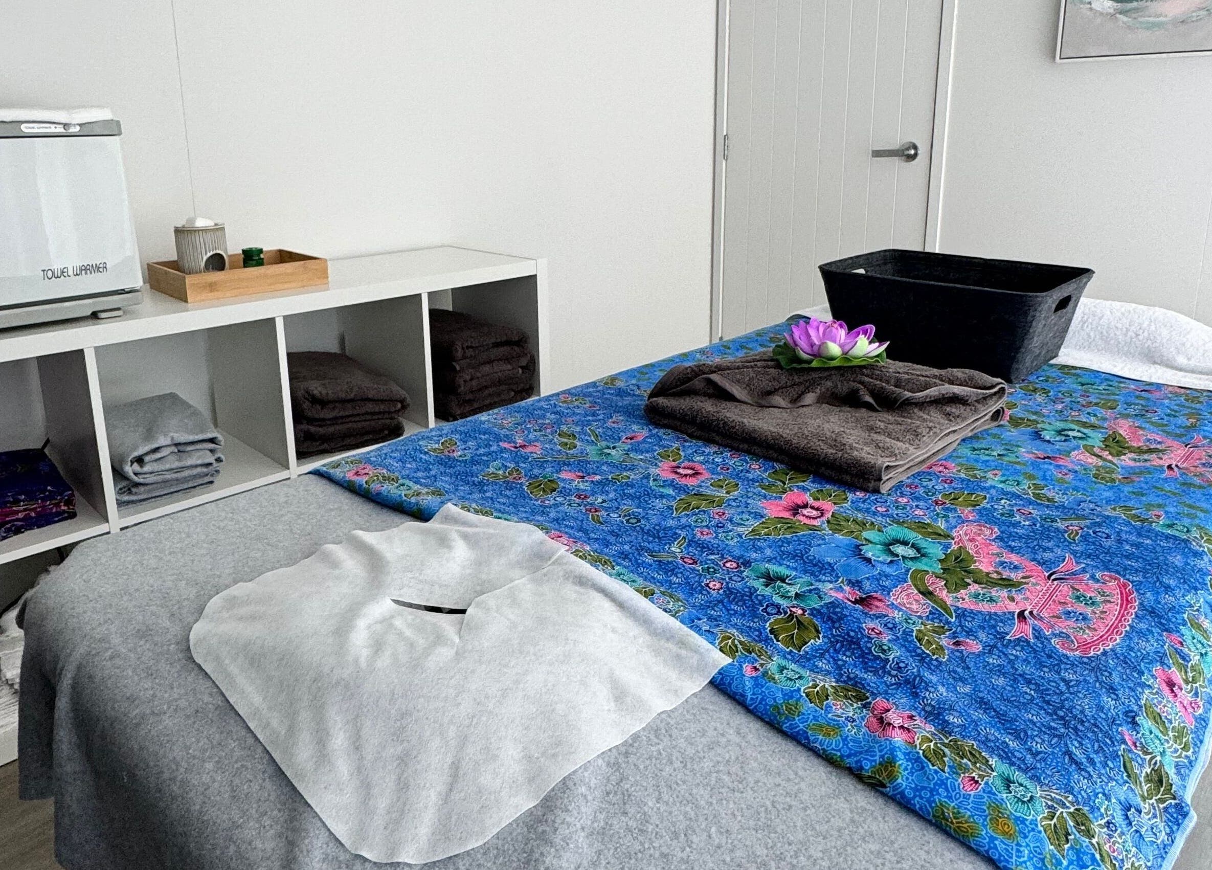 Cozy massage room at Massage Loft (Pukekohe) with floral bedspread in Pukekohe, Auckland, NZ.
