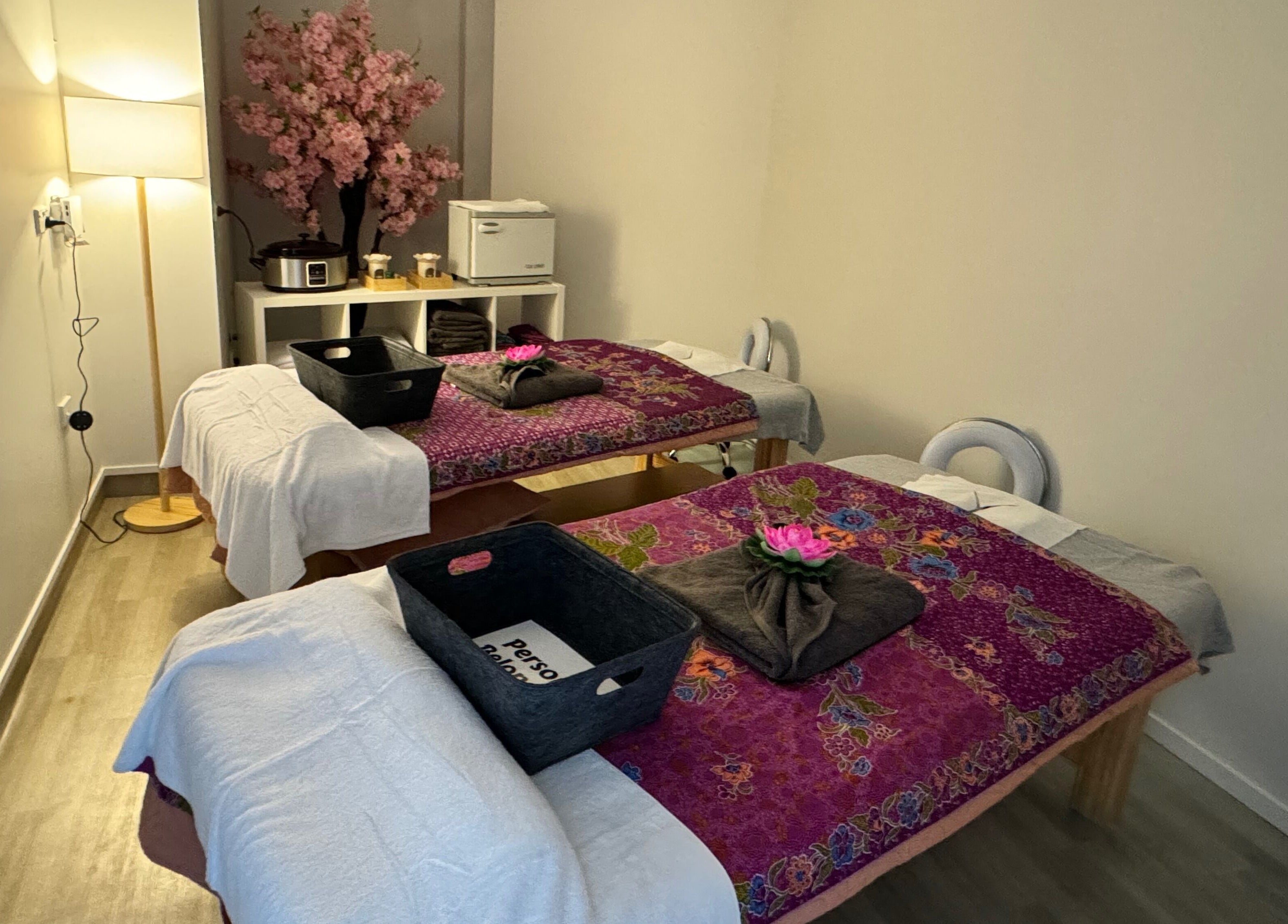 Relaxing twin massage beds at Massage Loft, Pukekohe, Auckland, NZ, adorned with bright floral decor.
