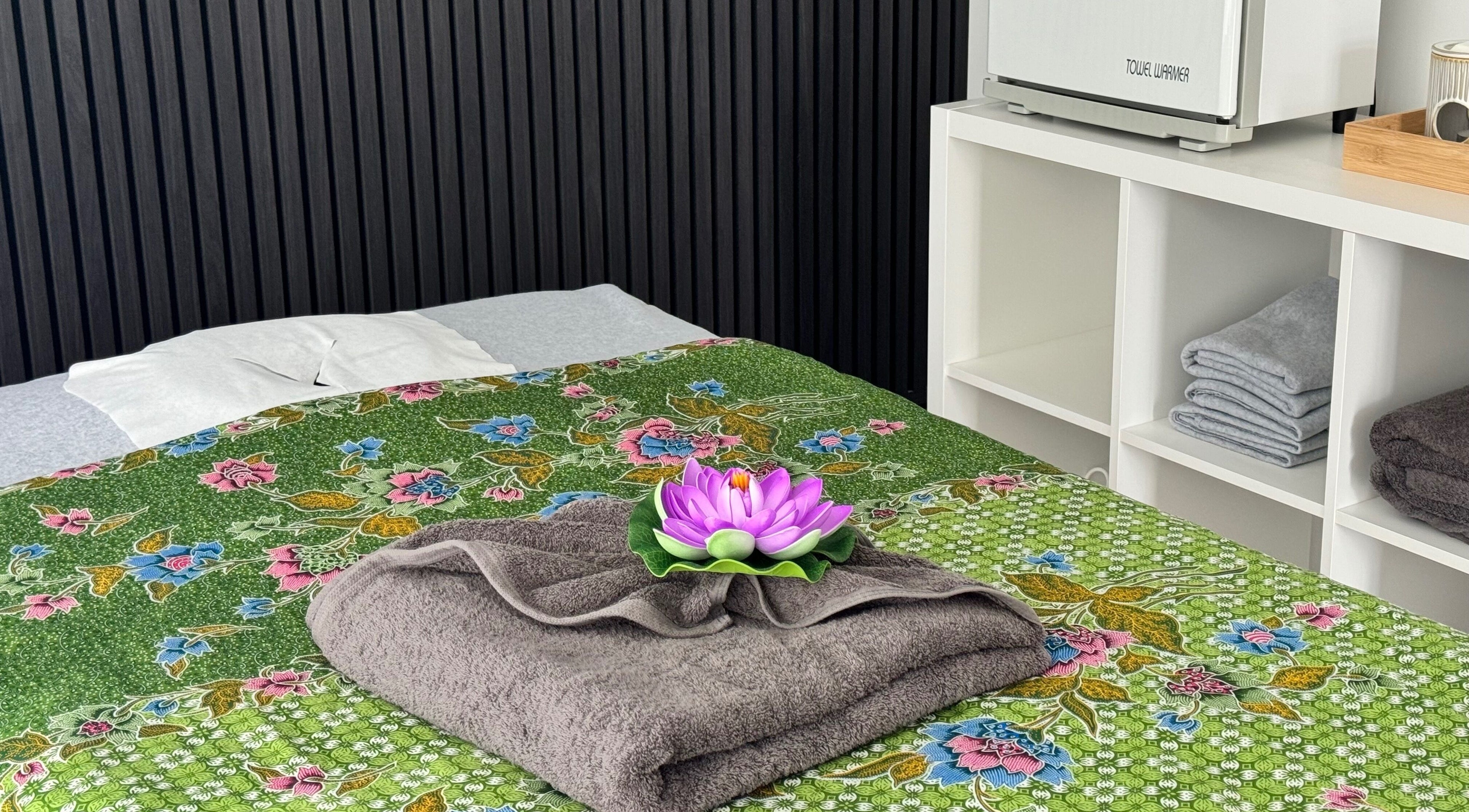 Massage table with floral sheet and towels at Massage Loft, Pukekohe, Auckland, NZ.
