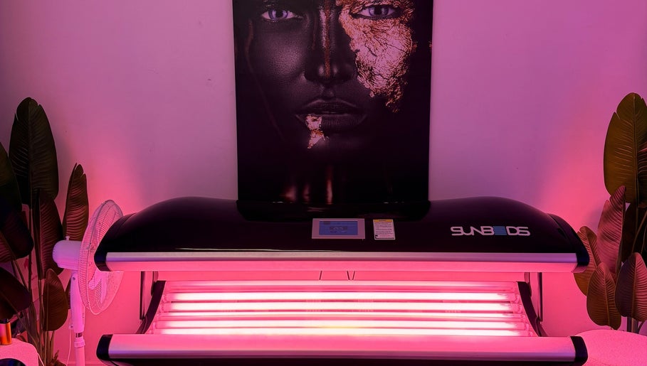 Sunbed at The Collarium Cult in Murarrie, Queensland, AU glows under vibrant pink lighting.