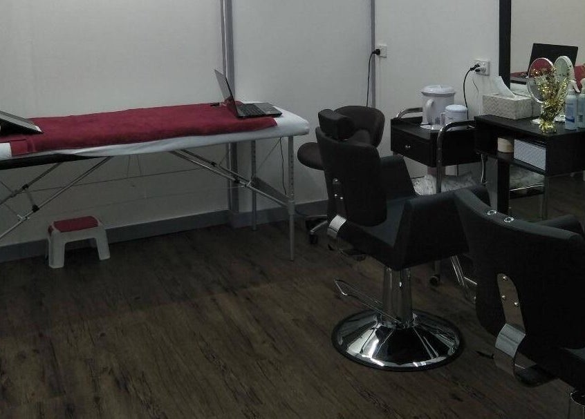 Chic treatment area at Bollywood cuts n brows in Melbourne, Victoria, AU with chairs and table.