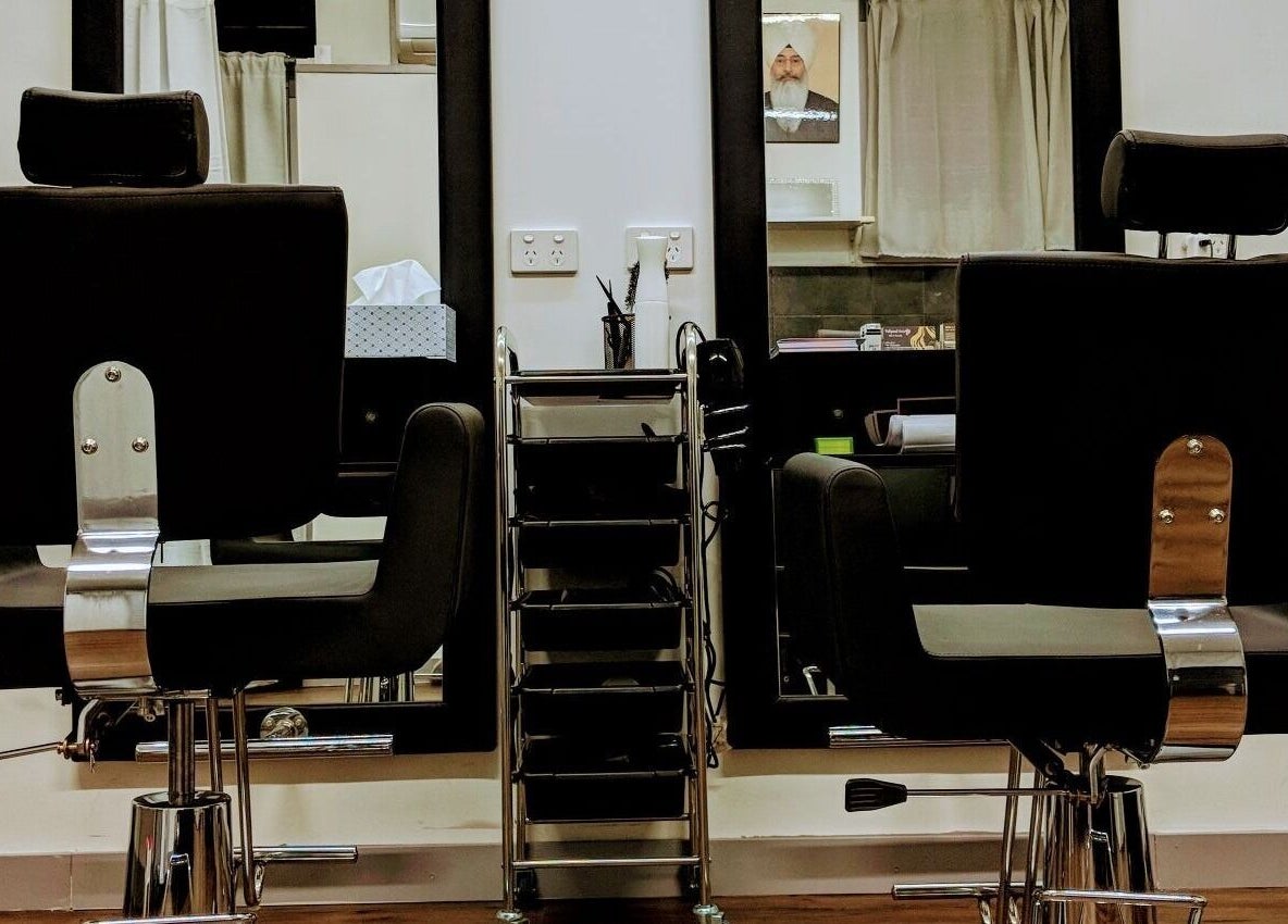 Modern styling chairs at Bollywood cuts n brows, Melbourne, Victoria, AU, showcasing sleek salon interior.