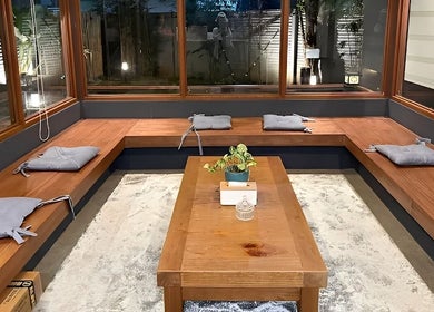 Relaxing seating area at Essa Spa & Nails in Lapu-lapu City, Central Visayas, PH with cushions and a central table.