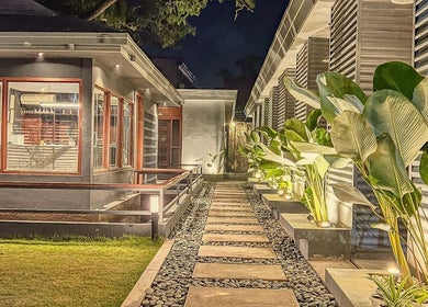 Tranquil evening view of Essa Spa & Nails, Lapu-lapu City, featuring serene walkway and lush greenery.