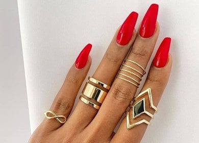 Stylish red manicured nails with gold rings at T-Royals Beauty, Cape Town, Western Cape, ZA.