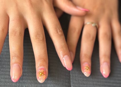 Intricate floral nail art at Beautitude, Clitheroe, England, GB showcasing pink designs with embellishments.