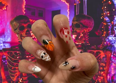 Halloween-themed nail art at Beautitude, Clitheroe, England, GB. Intricate designs include spiders and pumpkins.