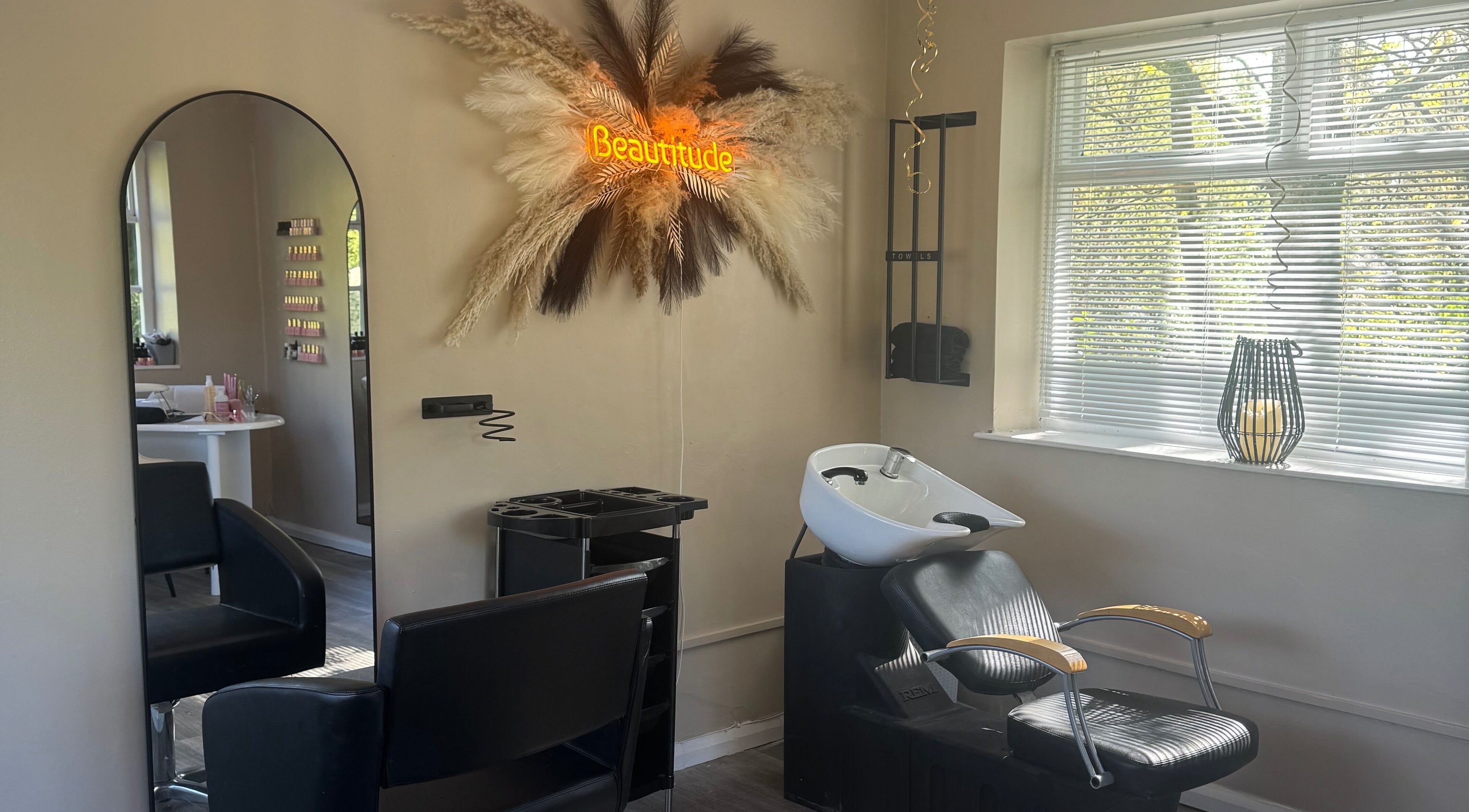 Elegant Beautitude salon in Clitheroe, England, GB with stylish decor and professional styling chair.