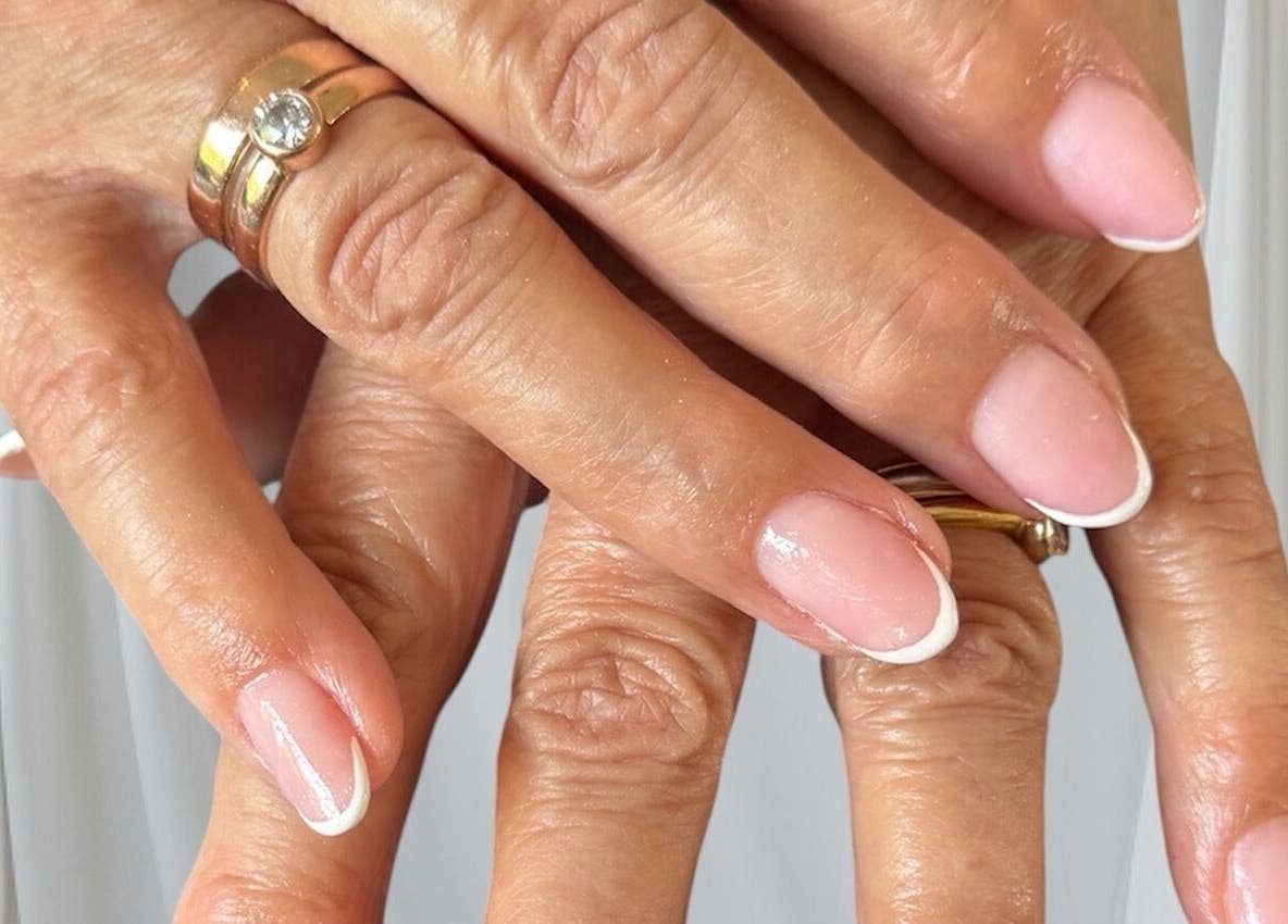 Elegant French manicure at Beautitude, Clitheroe, England, GB, showcasing refined nail art.