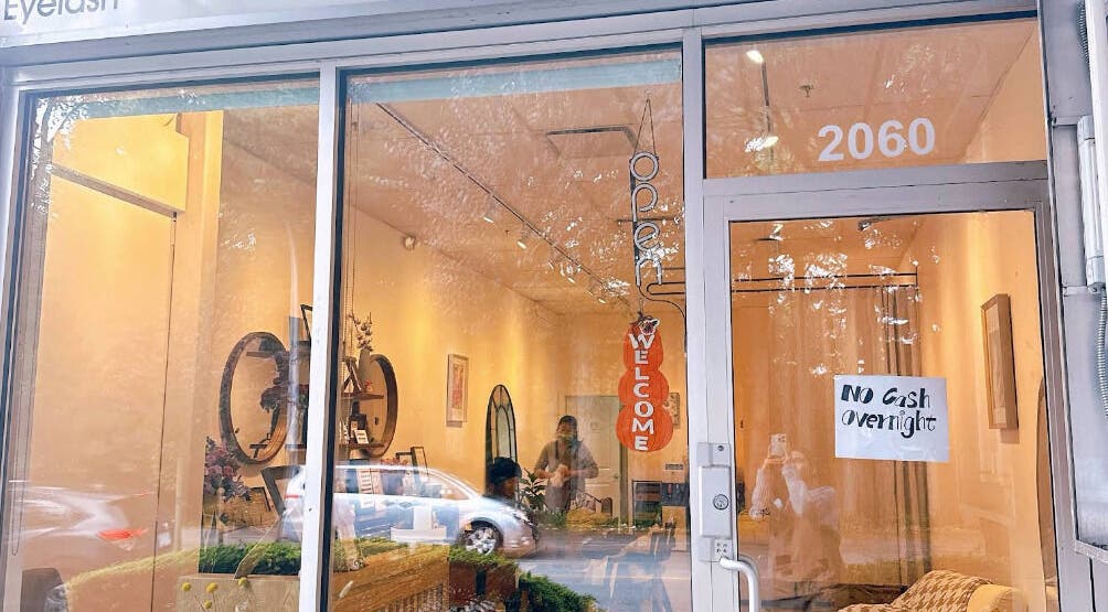 Entrance of Lunaria in Richmond, British Columbia, CA, showcasing a welcoming interior design through a glass door.