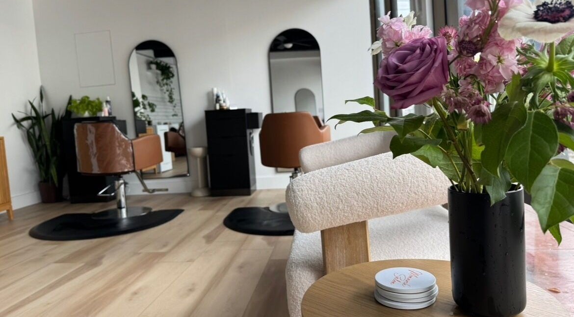 A chic setup at Monarch Salon on Union Street, San Francisco, California, US, featuring a stylish chair and fresh flowers.