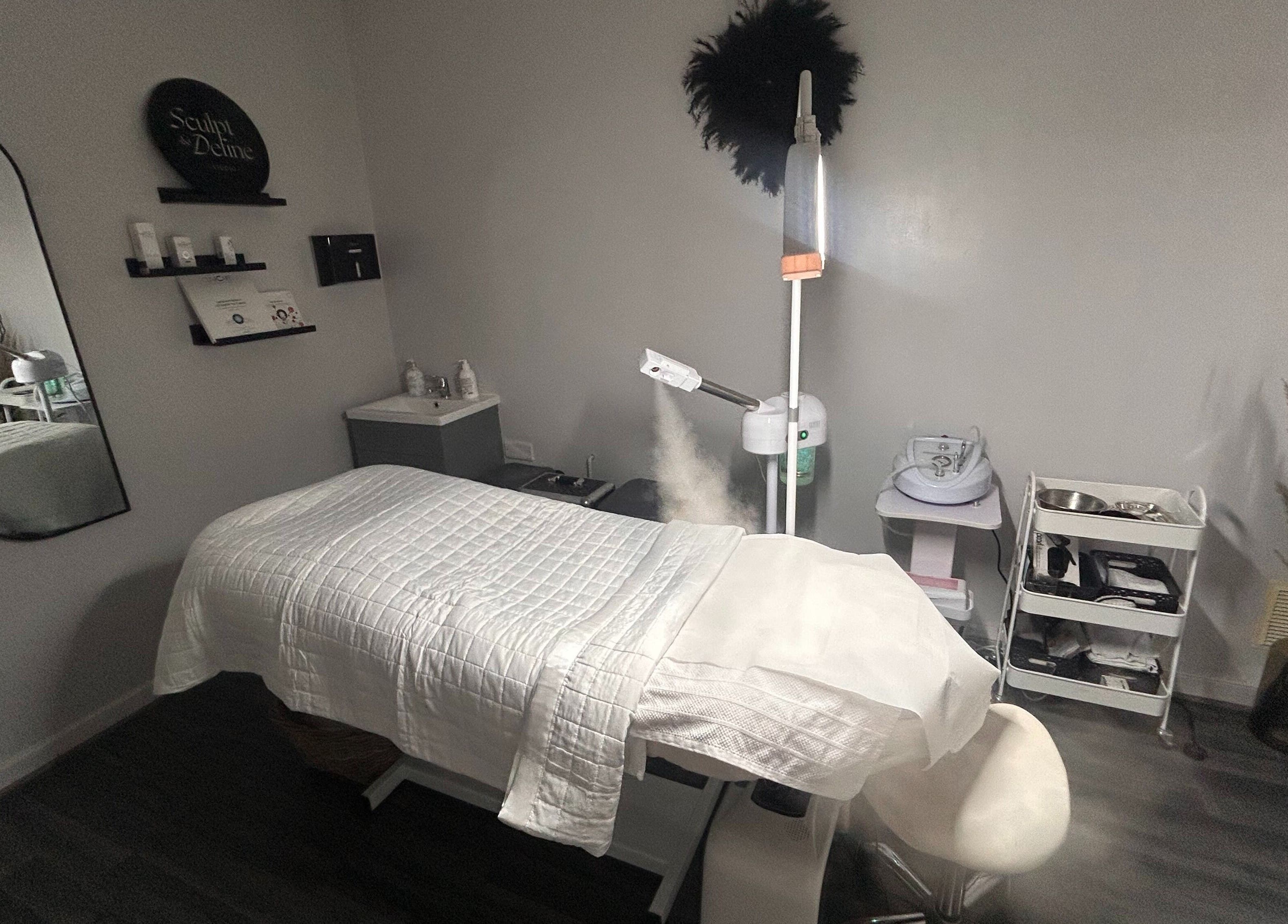 Relaxing treatment room at Sculpt & Define Studio, Pencader, Wales, GB with a massage table and spa equipment.