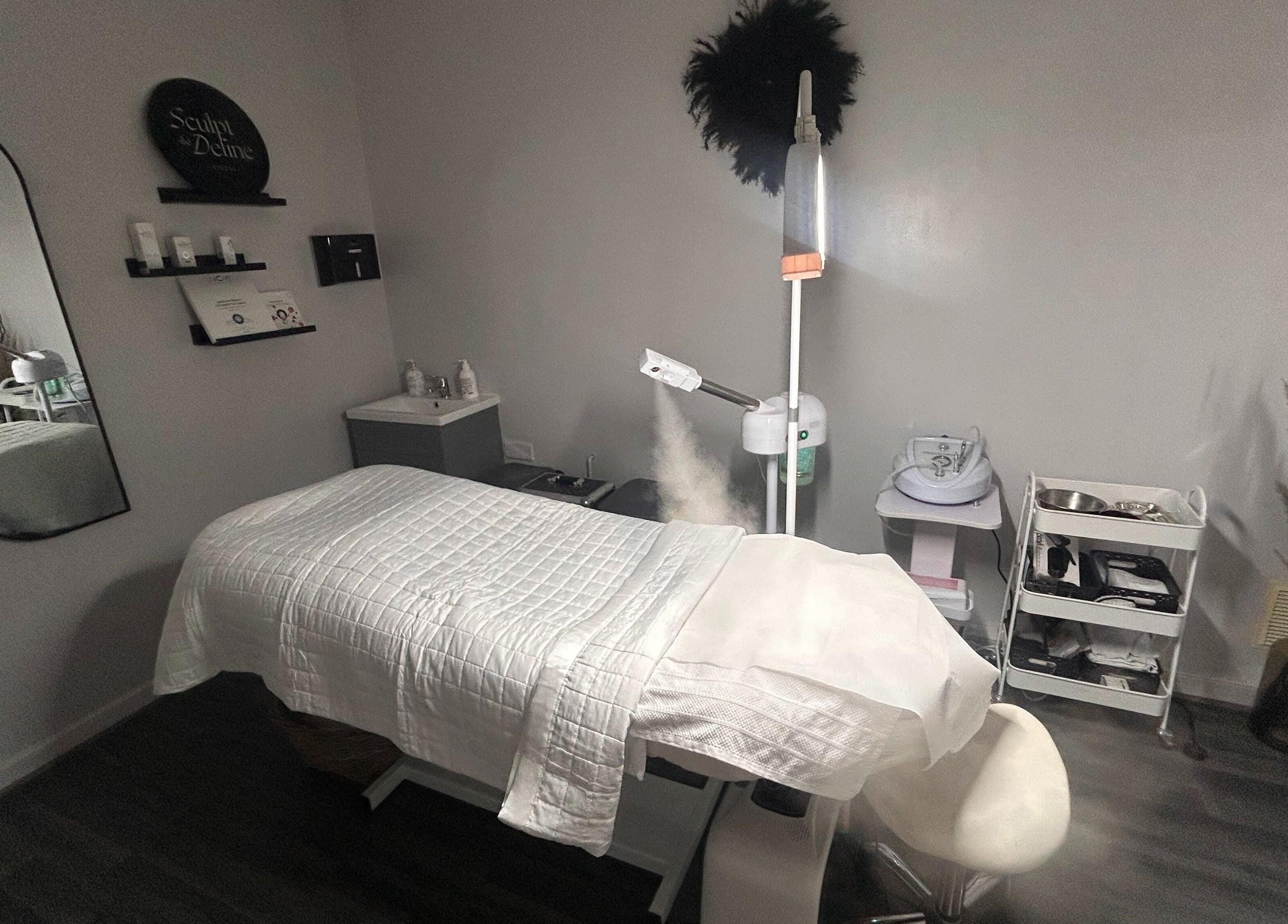 Relaxing treatment room at Sculpt & Define Studio, Pencader, Wales, GB with a massage table and spa equipment.