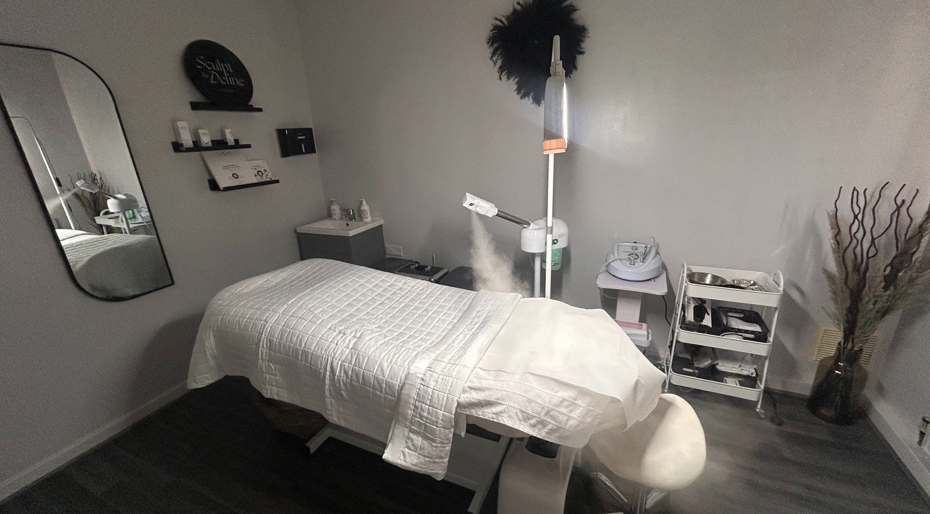 Relaxing treatment room at Sculpt & Define Studio, Pencader, Wales, GB with a massage table and spa equipment.