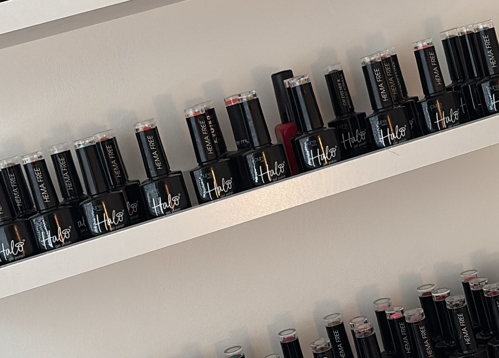 Elegant nail polish bottles on display at Beauty Hub, Peterborough, England, GB, showcasing variety.