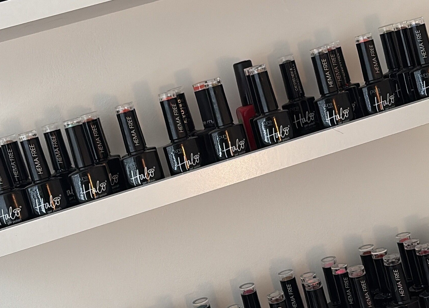 Elegant nail polish bottles on display at Beauty Hub, Peterborough, England, GB, showcasing variety.