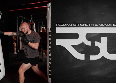 Boxer practicing with punching bag at Redding Strength & Conditioning, Albion Park Rail, New South Wales, AU.