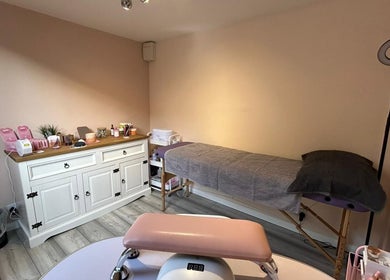 Tranquil treatment room at Emma's Place, Haverhill, England, GB, featuring a massage table and organized supplies.
