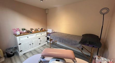 Tranquil treatment room at Emma's Place, Haverhill, England, GB, featuring a massage table and organized supplies.