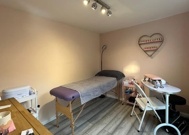 Cozy treatment room at Emma's Place, Haverhill, England, GB with a massage table and nail station.