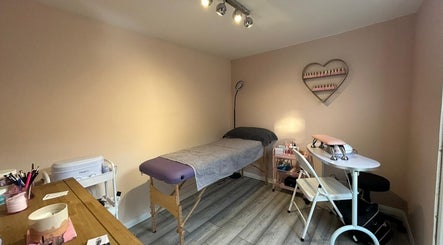 Cozy treatment room at Emma's Place, Haverhill, England, GB with a massage table and nail station.