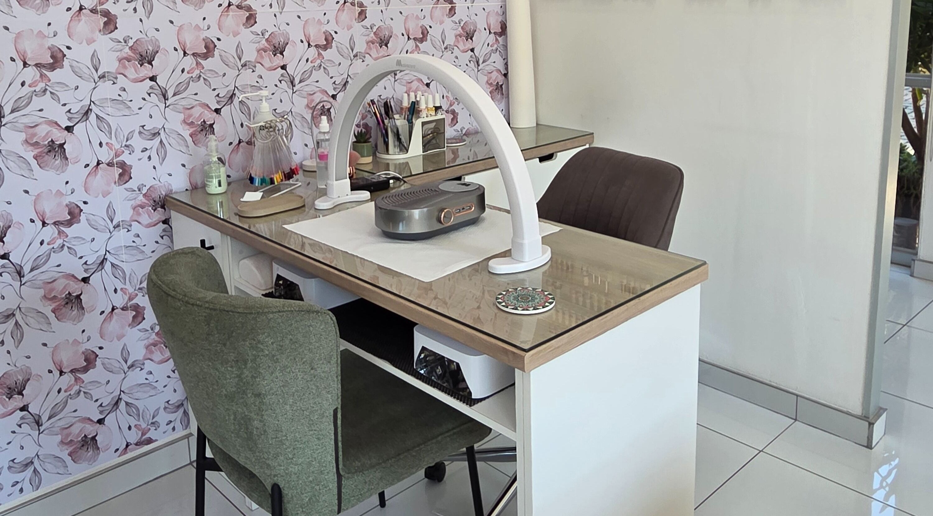 Stylish manicure station at Daniella Nail Studio in Randburg, Gauteng, ZA with floral walls and modern decor.