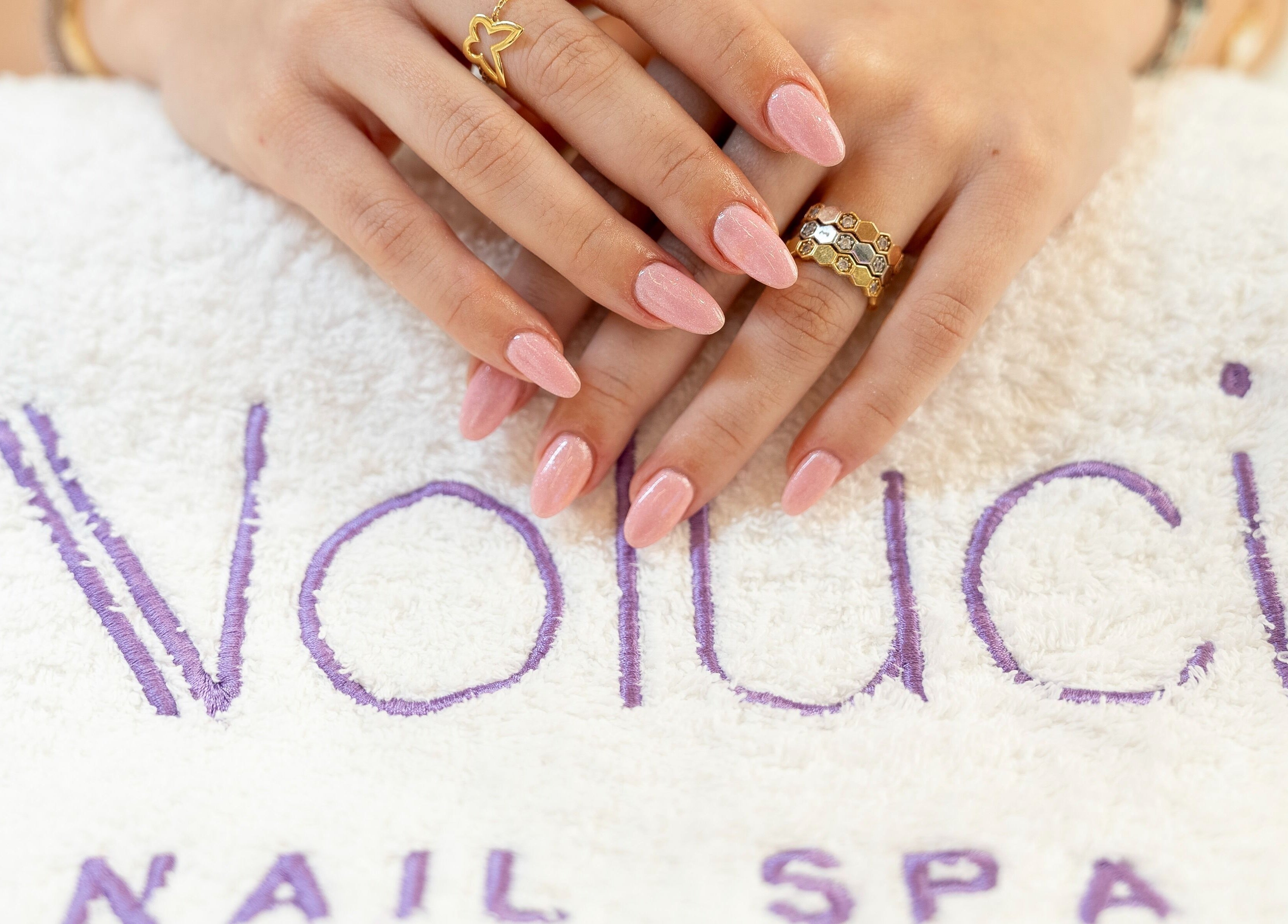 Elegant manicured hands resting on a Noluci Spa towel in الرياض, SA.