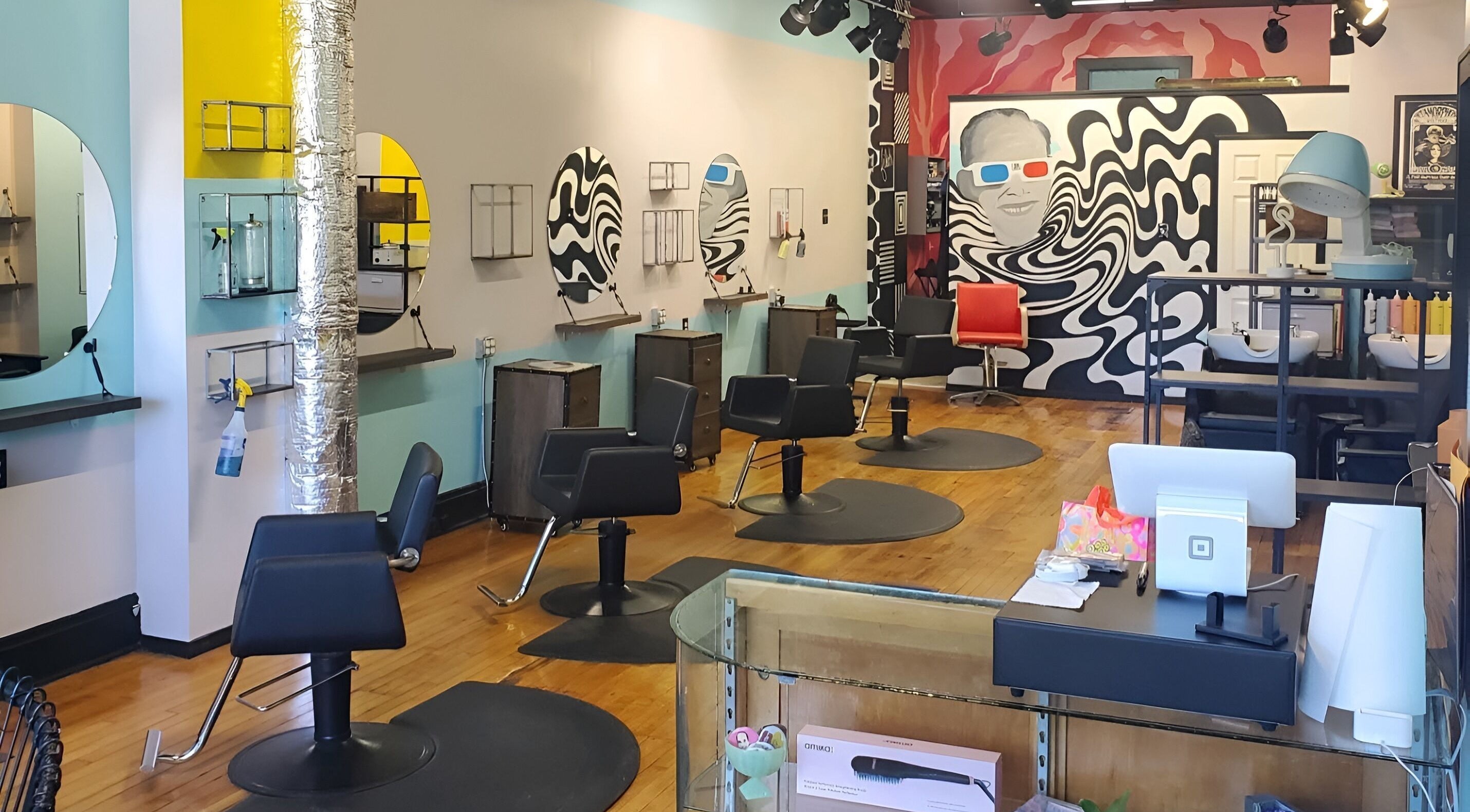 Interior of Dreamland: a Filthy Hair Salon in Lakewood, Ohio, US featuring modern chairs and artistic décor.