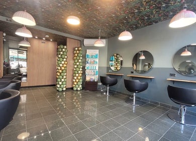 Modern salon interior at Carly Styles @ Artistic Hair Co., Bristol, England, GB, featuring elegant styling chairs.