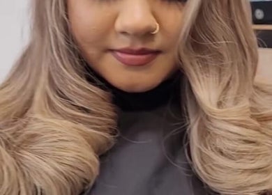 Woman with styled golden curls at Carly Styles @ Artistic Hair Co., Bristol, England, GB.