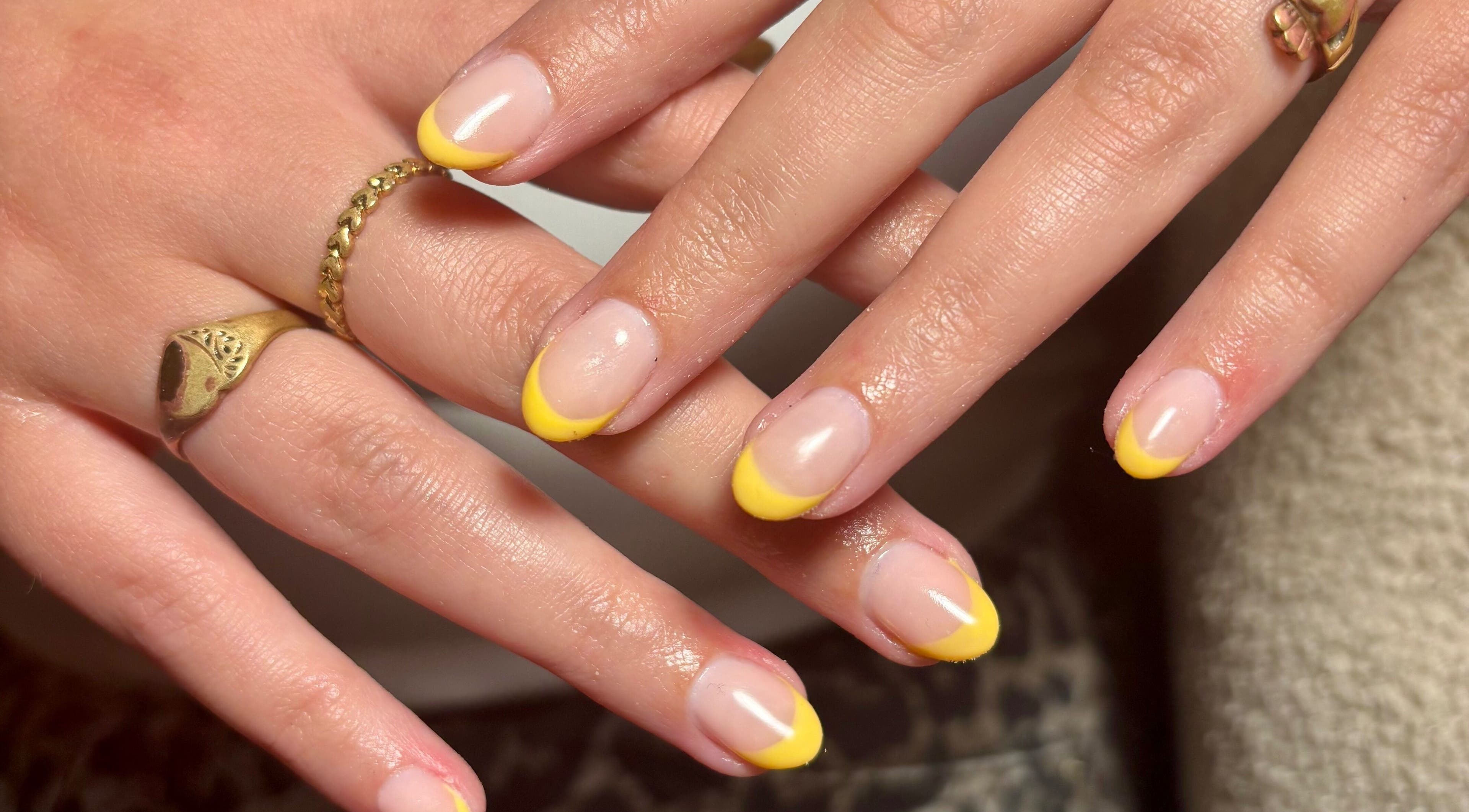 Stylish yellow-tipped nails at So Gel, Kesgrave, England, GB. Perfect for a chic manicure.