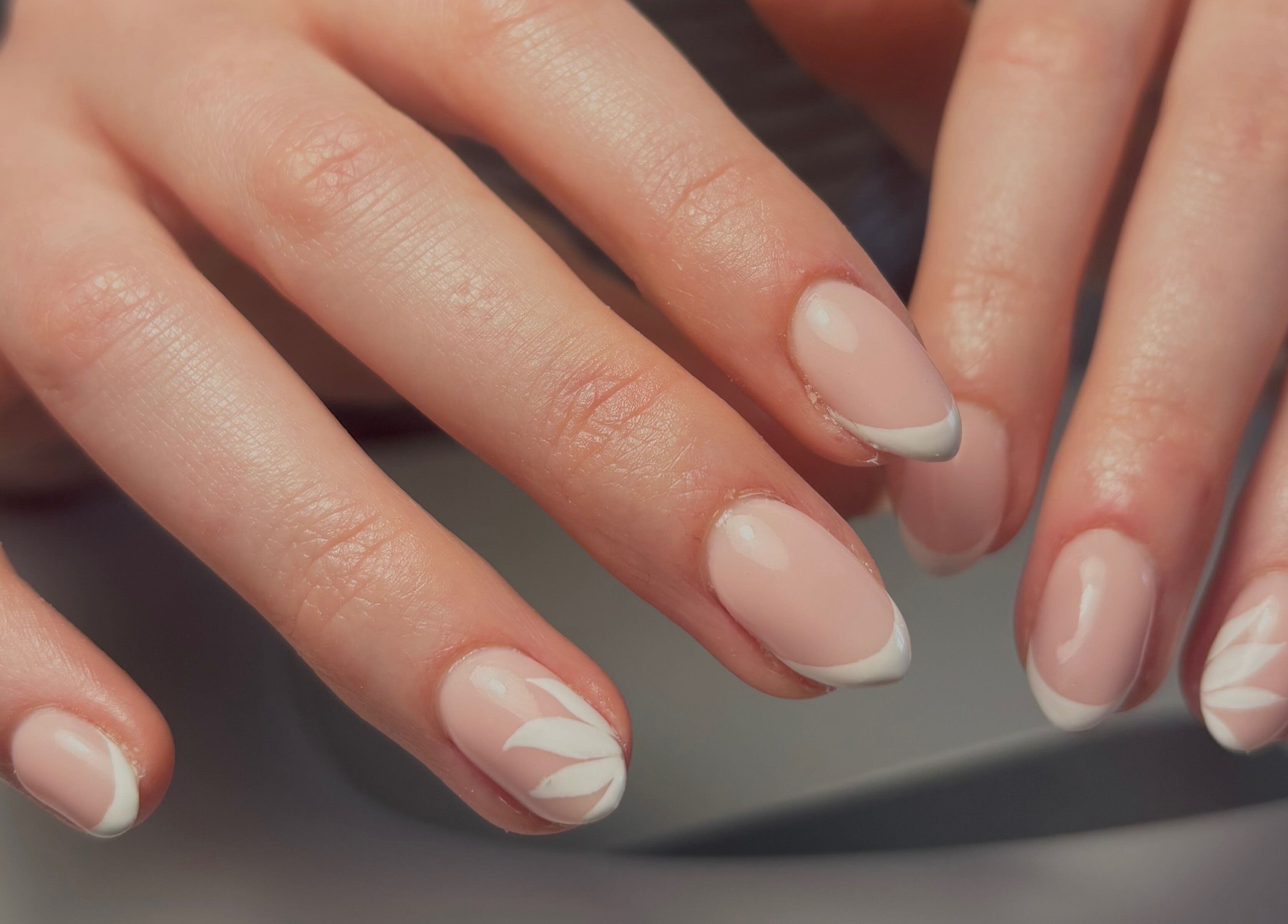 Elegant French manicure with delicate designs at So Gel in Kesgrave, England, GB.