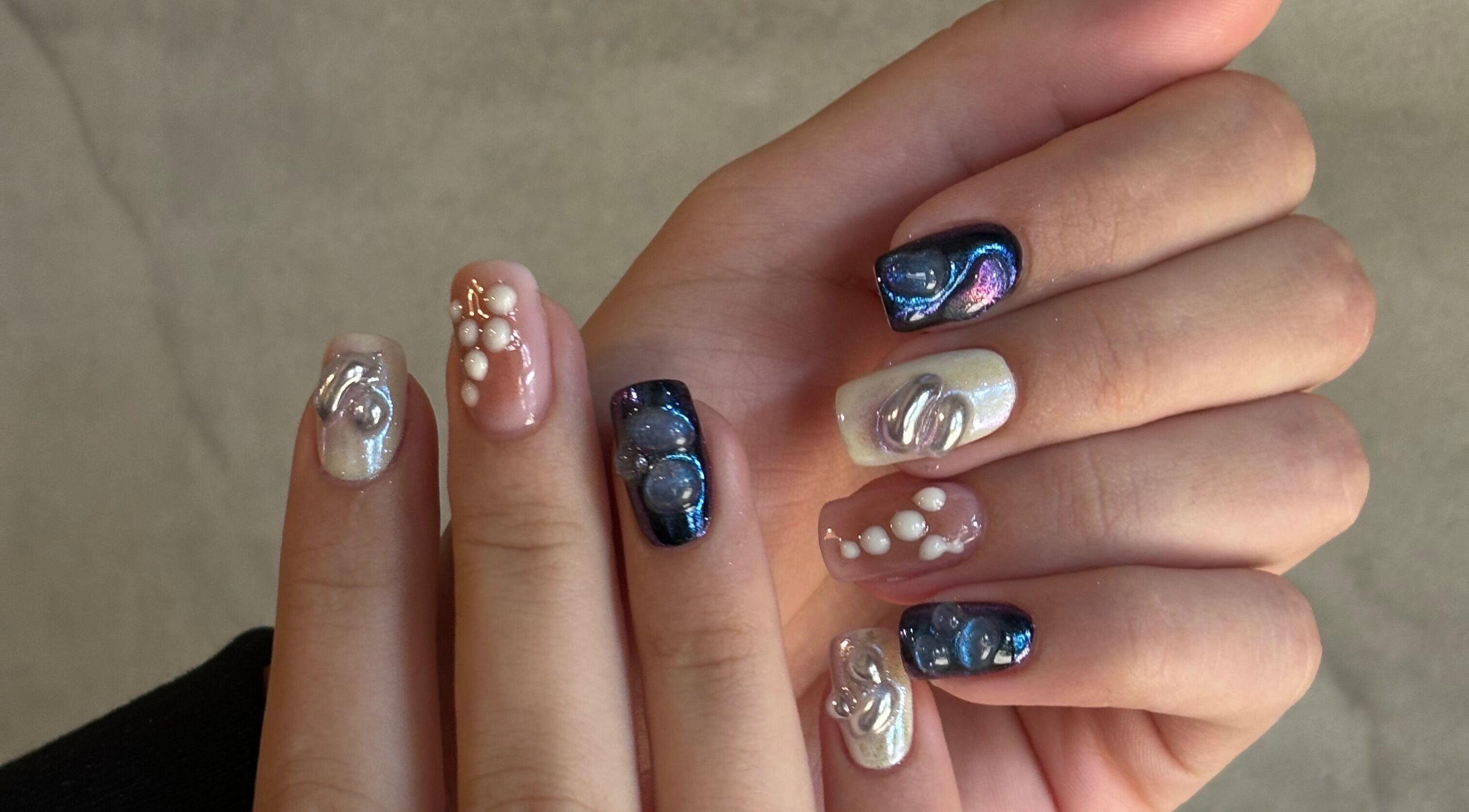 Stunning nail art at Agrresandra Nail Atelier, Sofia, featuring pearls and shimmer.