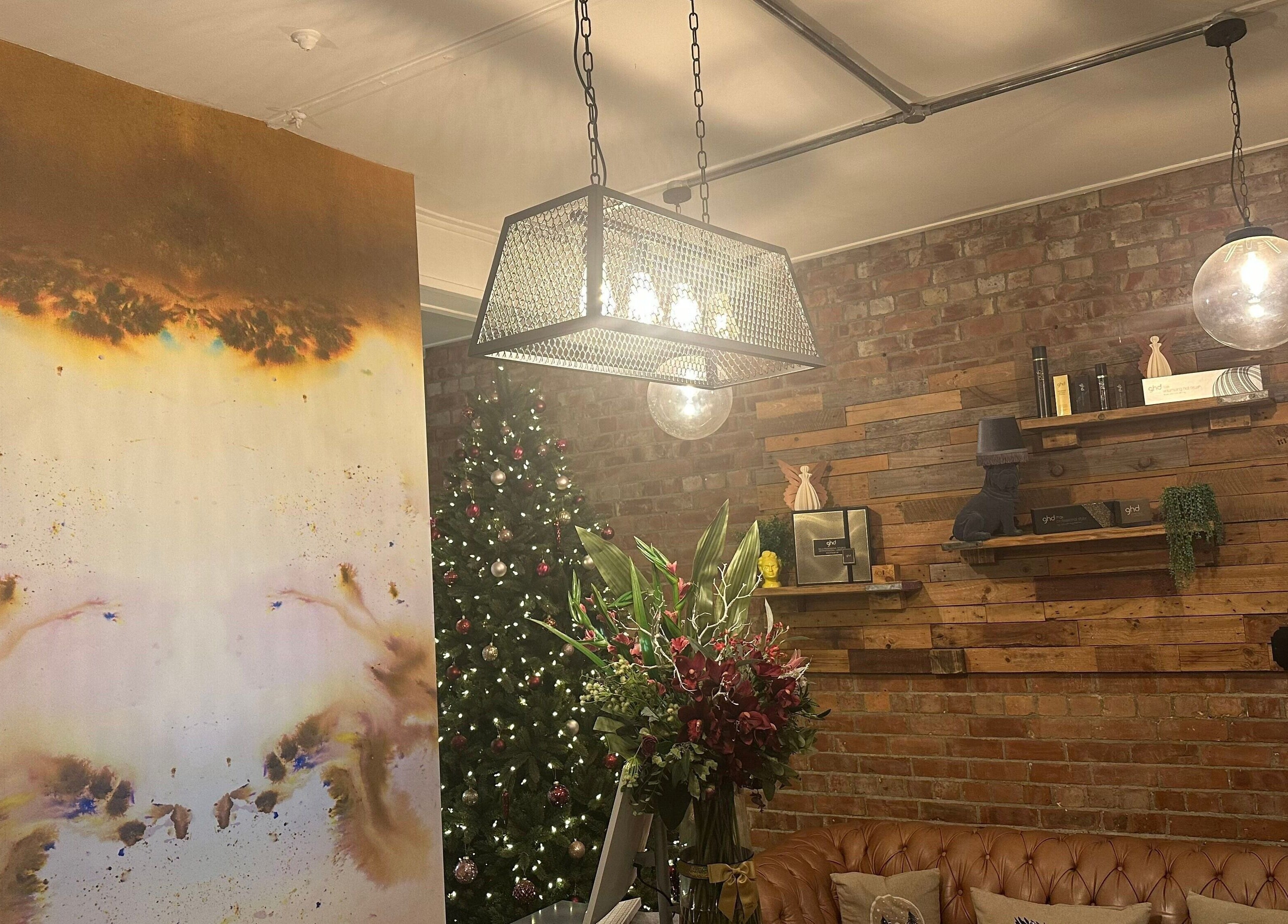 Cozy seating area at So & So Hairdressing, Whitley Bay, England, GB with chic decor and warm lighting.