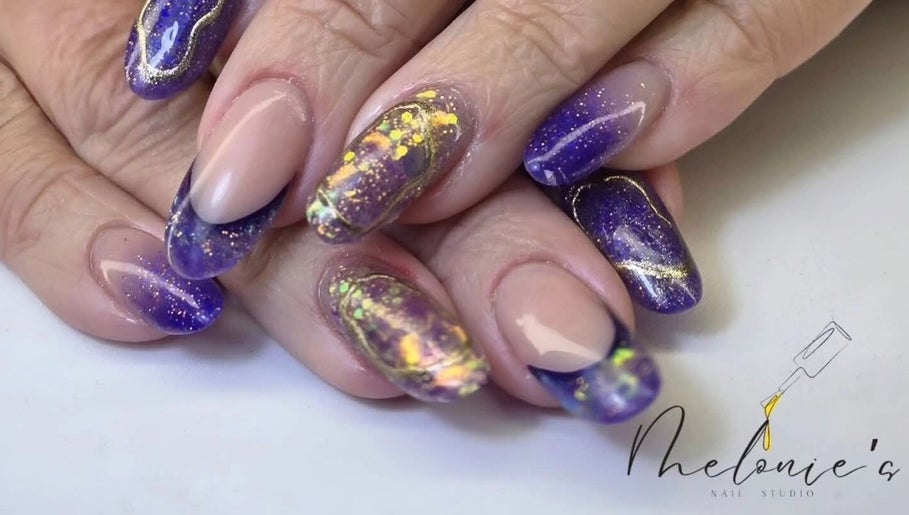 Stunning galaxy-themed nails at Melonie's Nail Salon, Hastings, England, GB, showcasing intricate purple nail art.