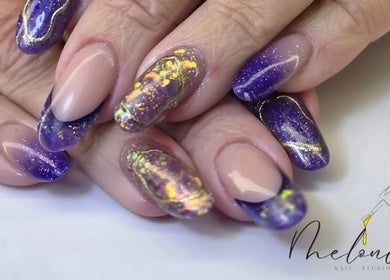 Stunning galaxy-themed nails at Melonie's Nail Salon, Hastings, England, GB, showcasing intricate purple nail art.